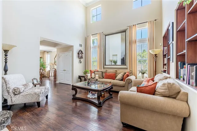 a living room with furniture and a book shelf