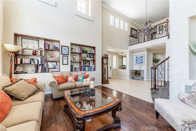 a living room with furniture a rug and a chandelier