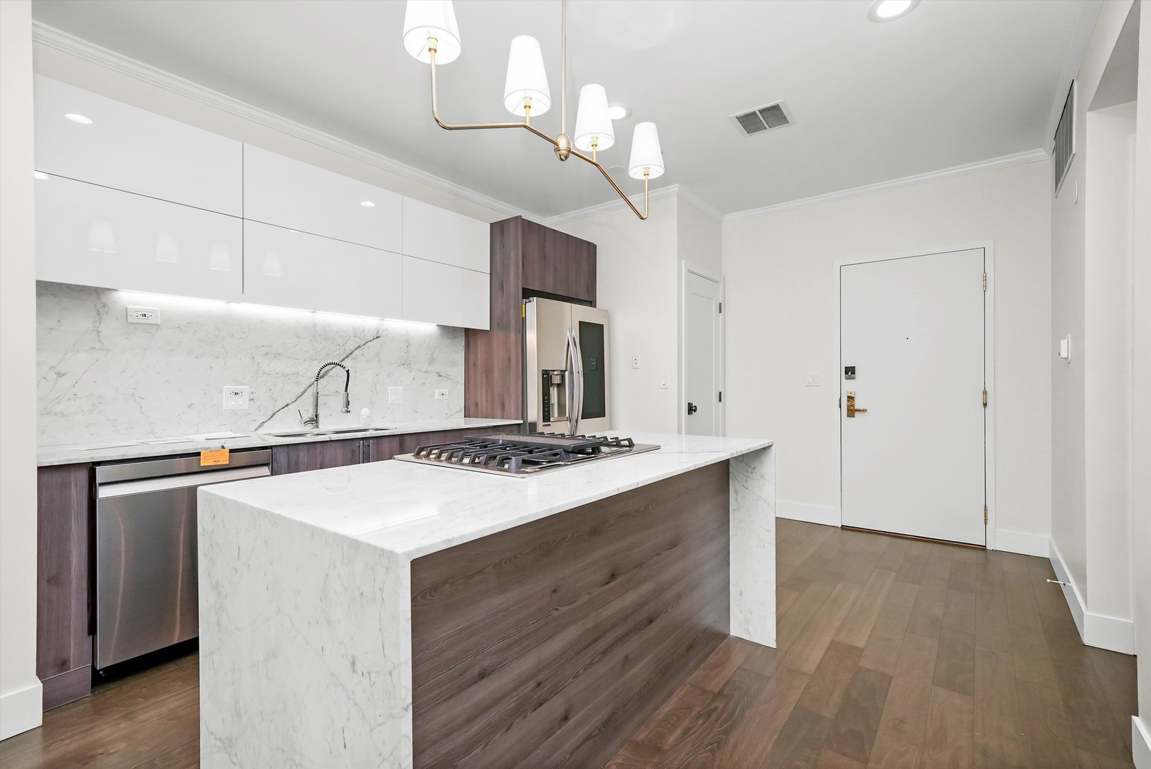 910 South Michigan Avenue, Unit 1612 Chicago, IL 60605 - Photo 5 of 17 a kitchen with a stove and a wooden floor
