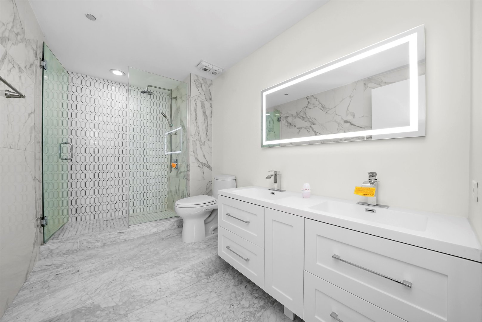 910 South Michigan Avenue, Unit 1612 Chicago, IL 60605 - Photo 10 of 17 a spacious bathroom with a sink a toilet and shower
