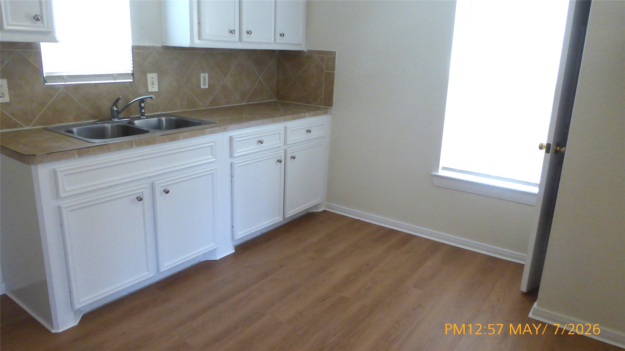 2308 Stevens Street Houston, TX 77026 - Photo 2 of 12 a kitchen with granite countertop white cabinets and sink