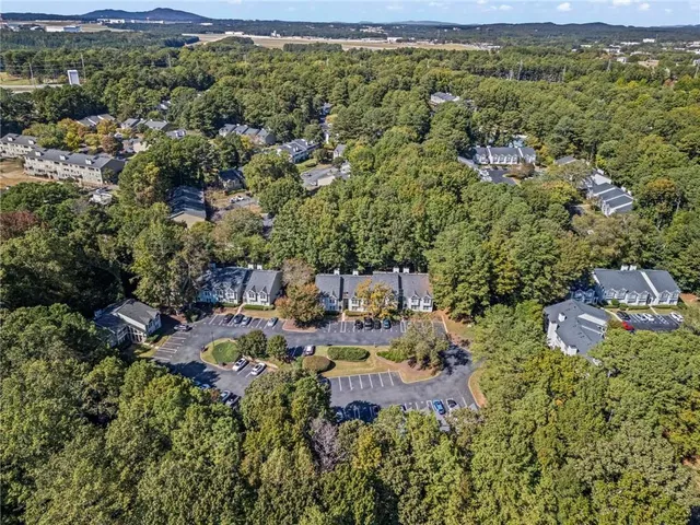 a view of a house with a street lush green forest