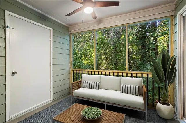 a balcony with furniture and a potted plant