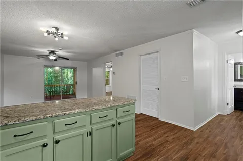 a bathroom with a granite countertop sink a large mirror and a window
