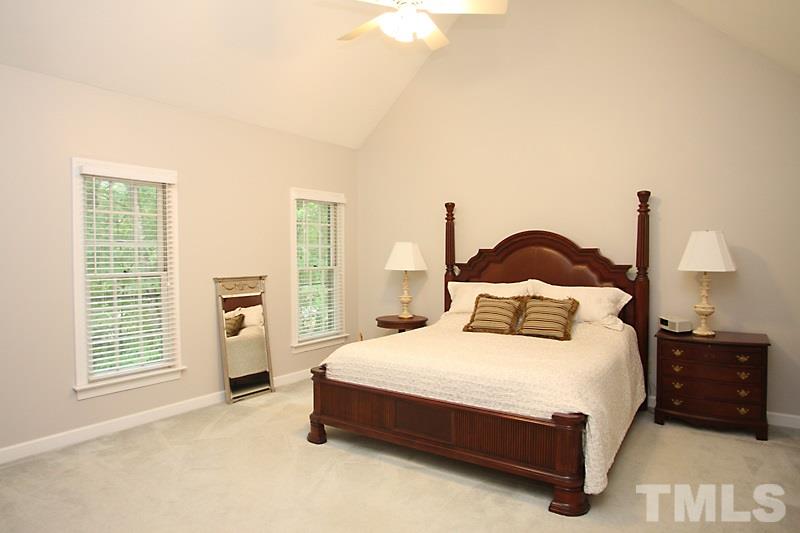 12301 Staunton Court Raleigh, NC 27613 - Photo 11 of 25 a bedroom with a bed and lamp