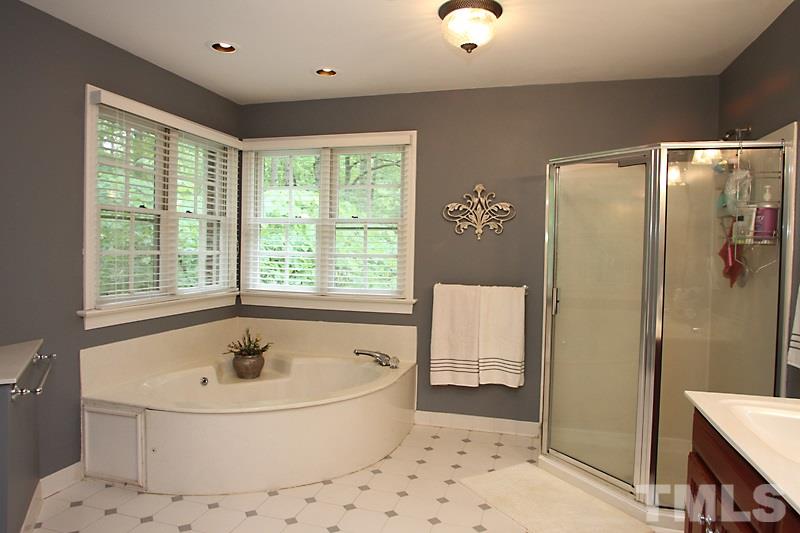 12301 Staunton Court Raleigh, NC 27613 - Photo 13 of 25 a bathroom with a bathtub and a shower