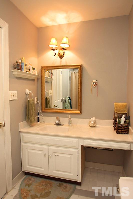 12301 Staunton Court Raleigh, NC 27613 - Photo 18 of 25 a bathroom with a sink and a mirror