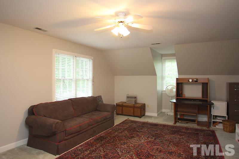 12301 Staunton Court Raleigh, NC 27613 - Photo 19 of 25 a living room with furniture a dining table and a piano