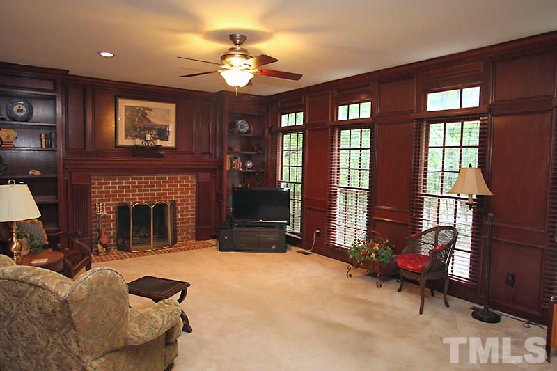 12301 Staunton Court Raleigh, NC 27613 - Photo 5 of 25 a living room with furniture a chandelier and a fireplace