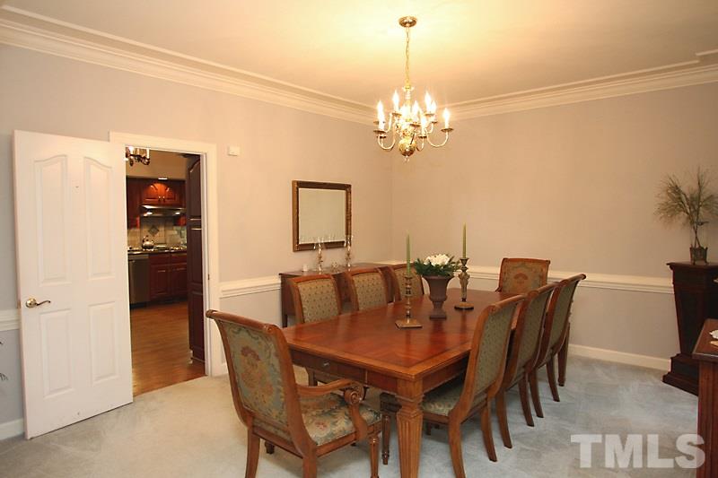 12301 Staunton Court Raleigh, NC 27613 - Photo 9 of 25 a view of a dining room with furniture and chandelier