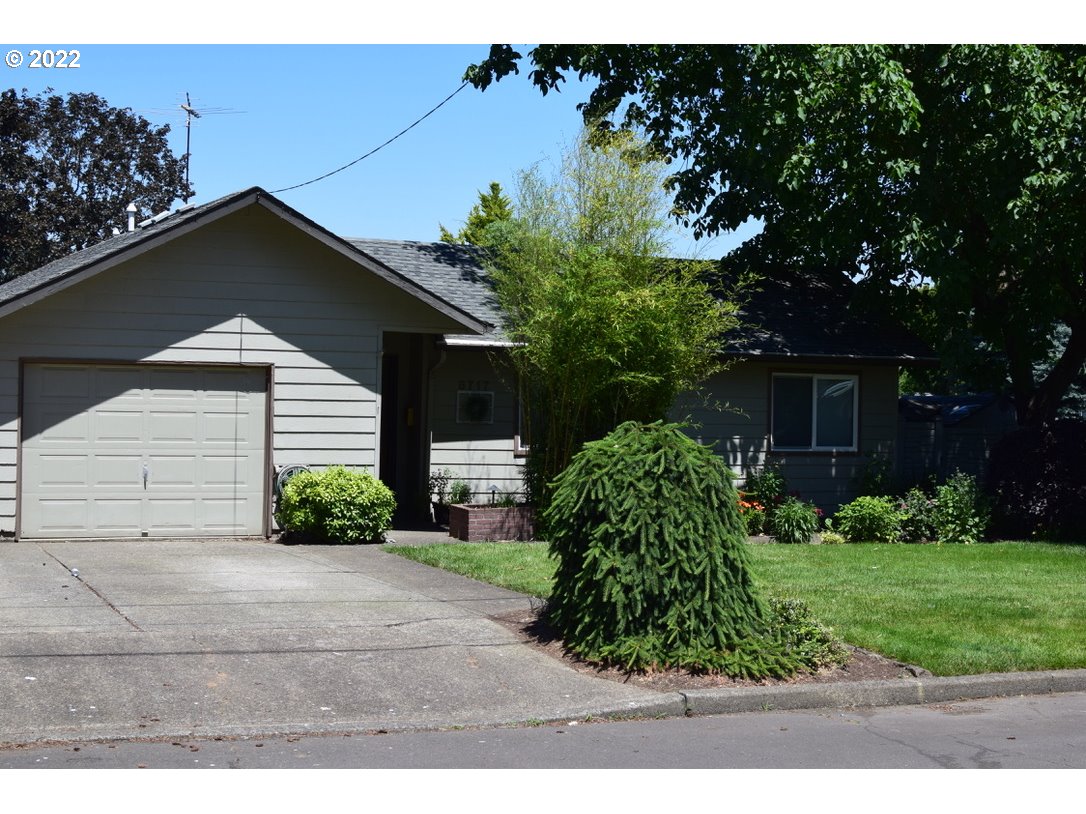 8717 Northeast Webster Street Portland, OR 97220 - Photo 1 of 30 a front view of a house with a yard and potted plants