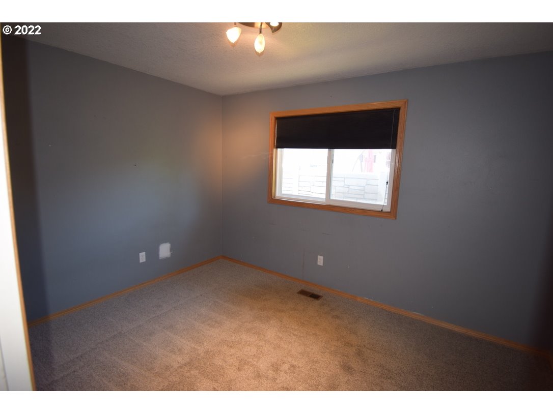 8717 Northeast Webster Street Portland, OR 97220 - Photo 11 of 30 a view of an empty room with a window