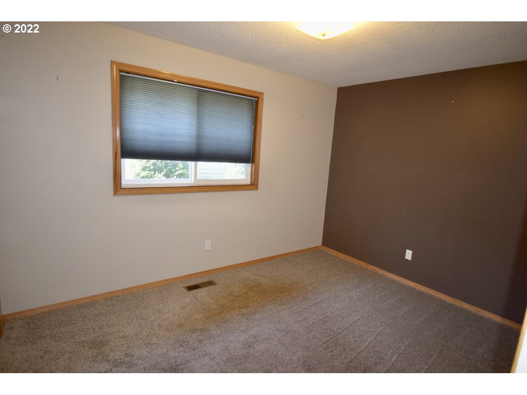 8717 Northeast Webster Street Portland, OR 97220 - Photo 12 of 30 a view of an empty room with a window