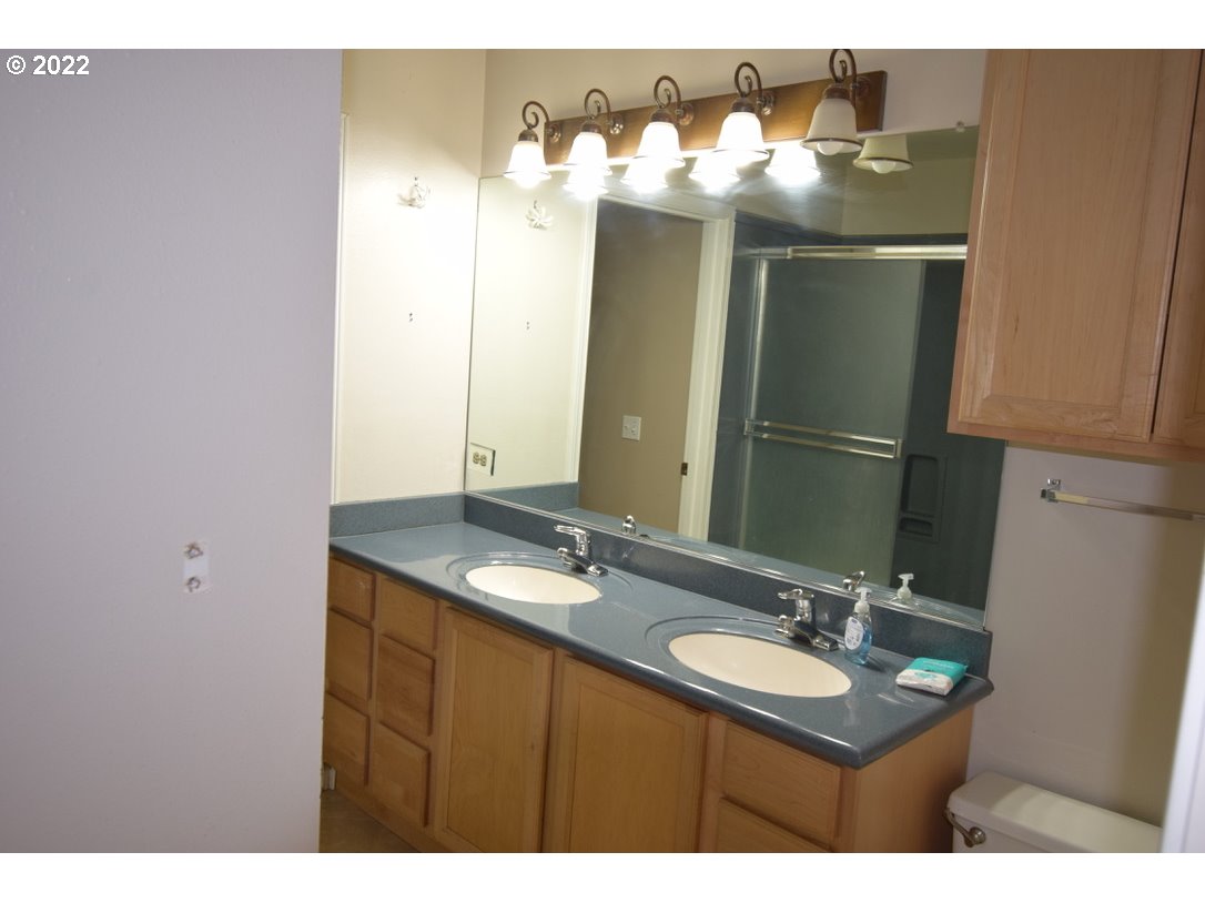 8717 Northeast Webster Street Portland, OR 97220 - Photo 13 of 30 a bathroom with a sink and a mirror