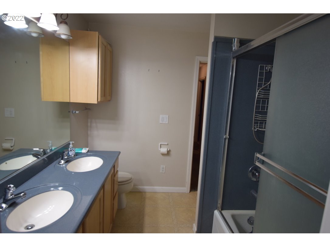 8717 Northeast Webster Street Portland, OR 97220 - Photo 14 of 30 a bathroom with a sink vanity granite and a mirror