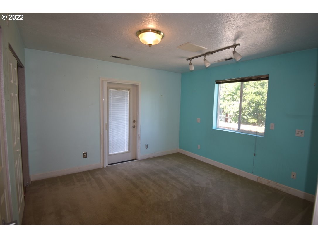 8717 Northeast Webster Street Portland, OR 97220 - Photo 18 of 30 a view of empty room with window