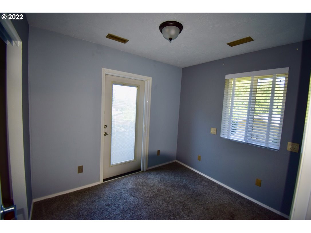 8717 Northeast Webster Street Portland, OR 97220 - Photo 19 of 30 a view of an empty room with a window
