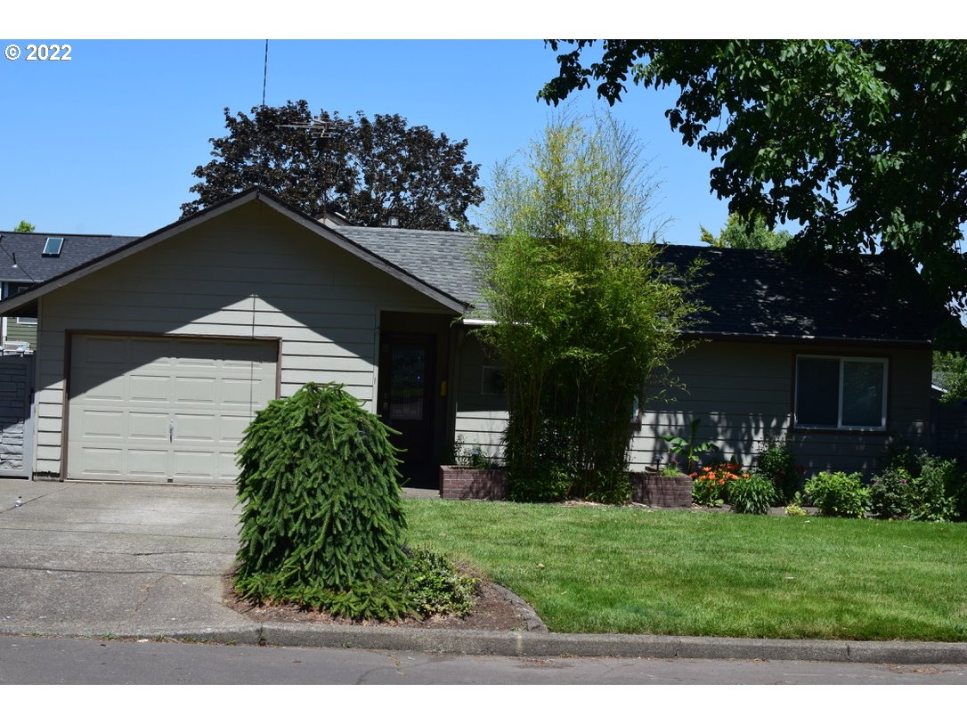 8717 Northeast Webster Street Portland, OR 97220 - Photo 2 of 30 a backyard of a house with lots of green space