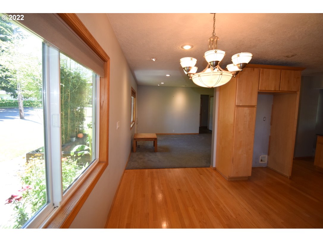 8717 Northeast Webster Street Portland, OR 97220 - Photo 8 of 30 a view of a room with wooden floor and large windows