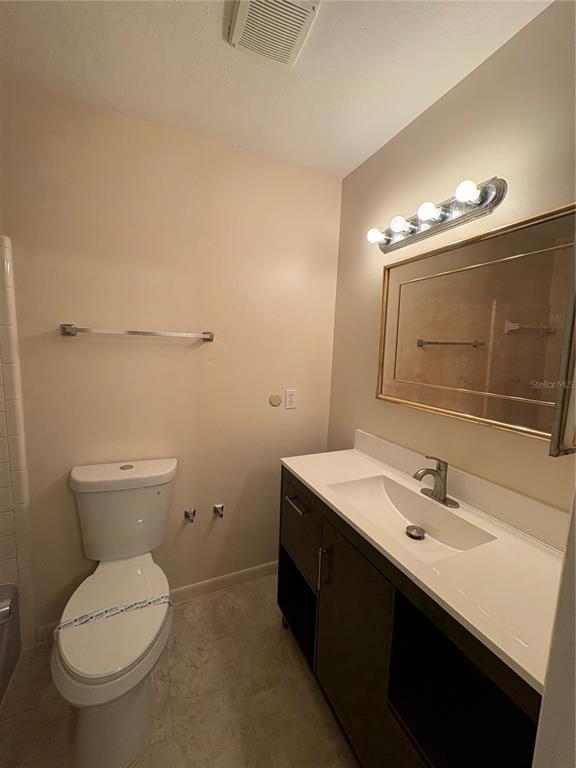 5107 East 120th Avenue Temple Terrace, FL 33617 - Photo 15 of 24 a bathroom with a toilet sink and mirror