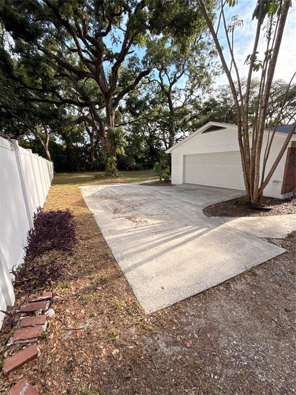 5107 East 120th Avenue Temple Terrace, FL 33617 - Photo 19 of 24 a view of backyard with large trees