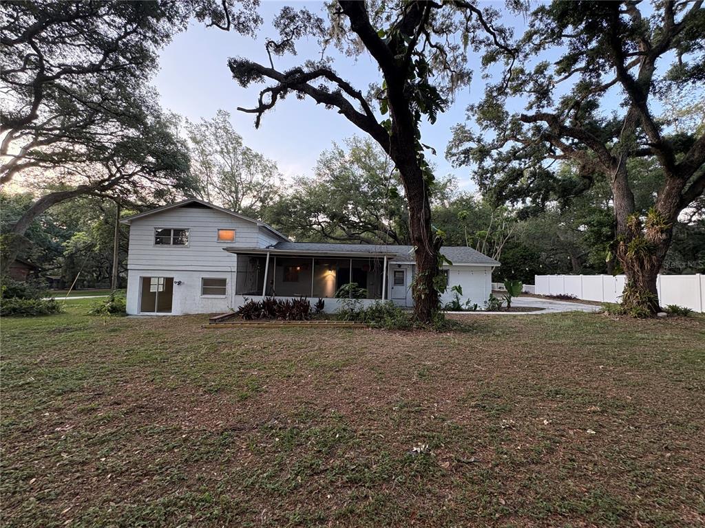 5107 East 120th Avenue Temple Terrace, FL 33617 - Photo 20 of 24 a front view of a house with a yard