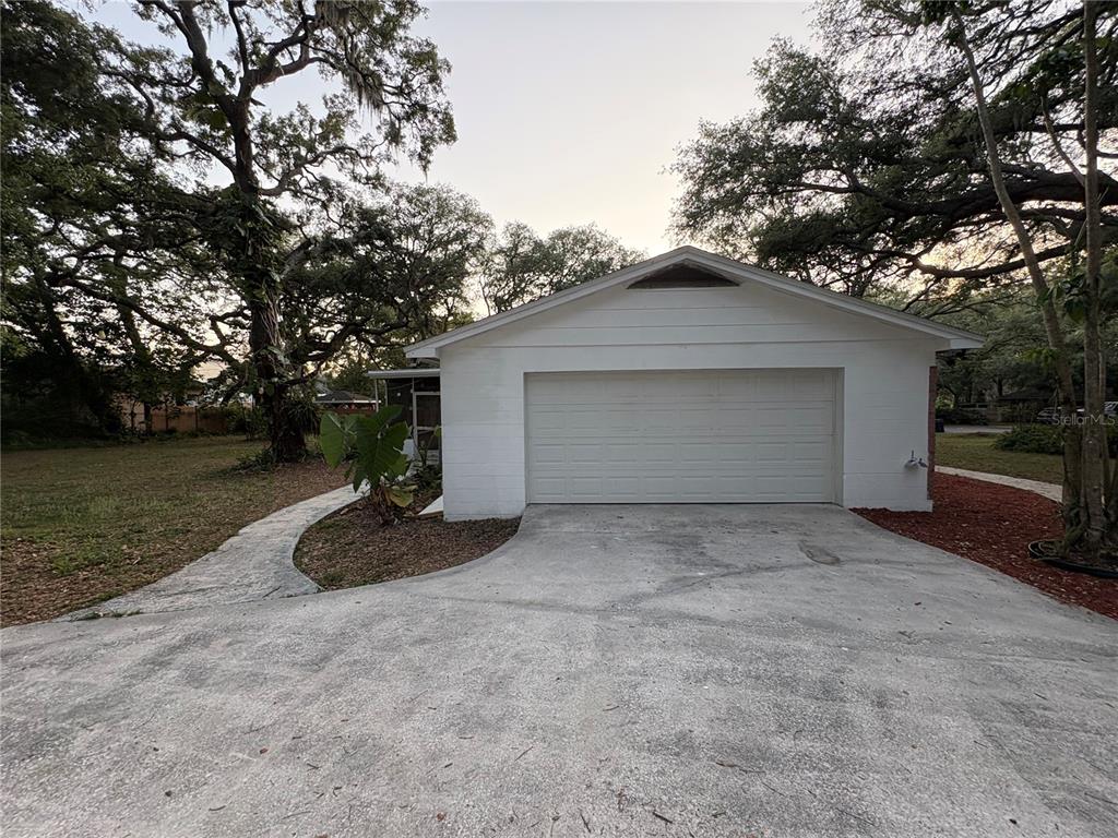5107 East 120th Avenue Temple Terrace, FL 33617 - Photo 23 of 24 a view of backyard of house and garage
