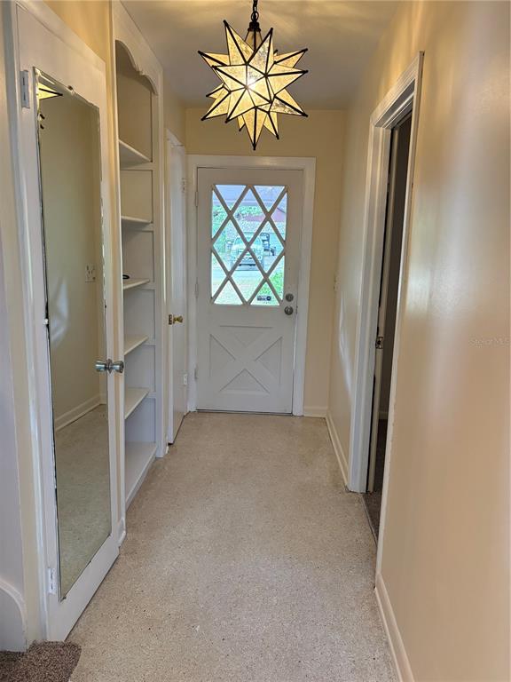 5107 East 120th Avenue Temple Terrace, FL 33617 - Photo 7 of 24 a view of entryway with a chandelier fan and a window