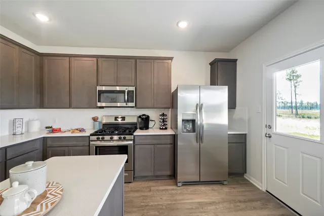 a kitchen with stainless steel appliances a refrigerator stove and sink