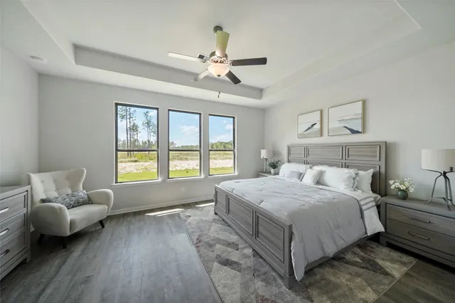 an empty room with windows and ceiling fan