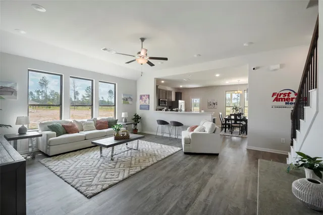a living room with furniture or couch and a large window