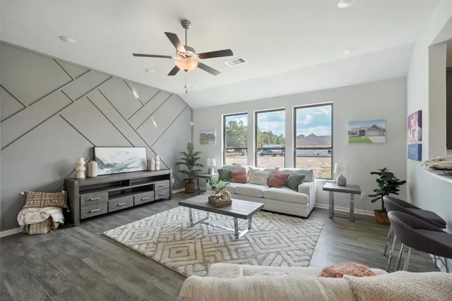 a living room with furniture and wooden floor