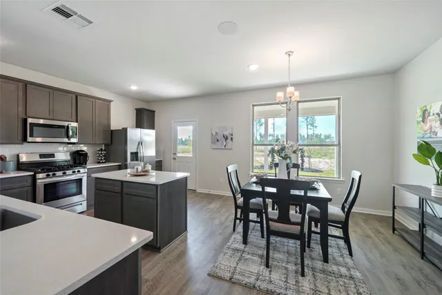 a view of a dining room with furniture window and wooden floor