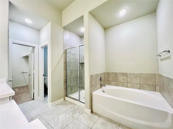 a spacious bathroom with a bathtub and a shower
