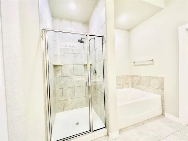 a bathroom with a glass shower door