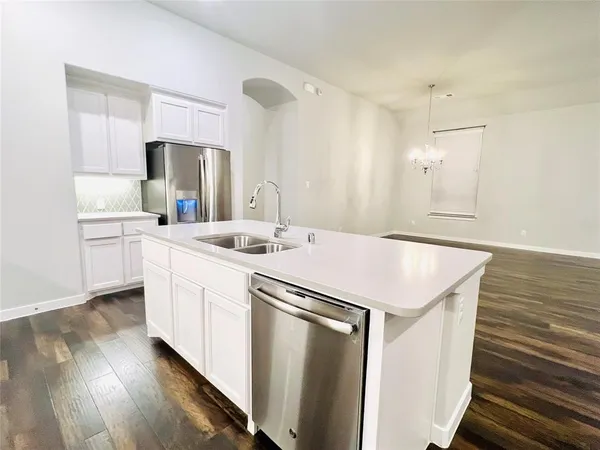 a kitchen with a sink and a refrigerator