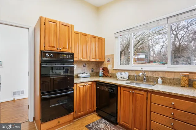a kitchen with a sink stove and cabinets