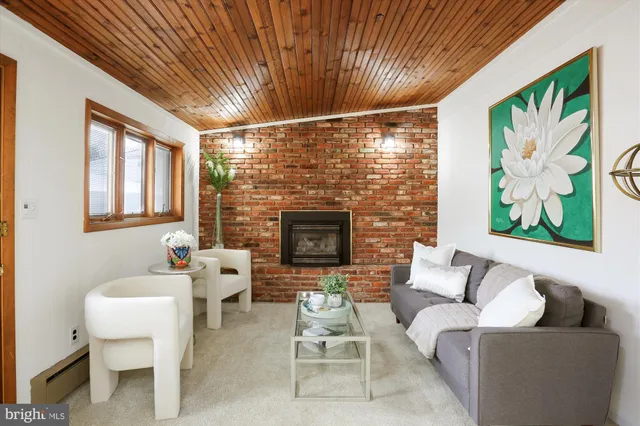 a living room with furniture a fireplace and a table