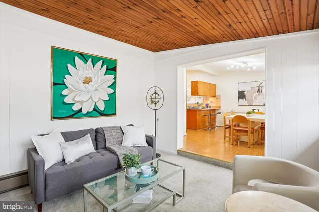 a living room with furniture and wall paintings