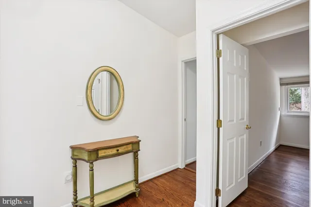 a view of a room with wooden floor and white walls