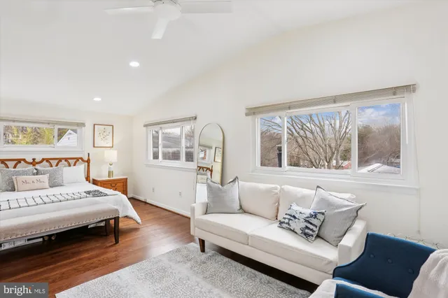 a bedroom with furniture and a large window