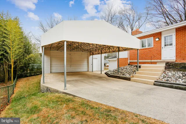 a view of a white house with a yard