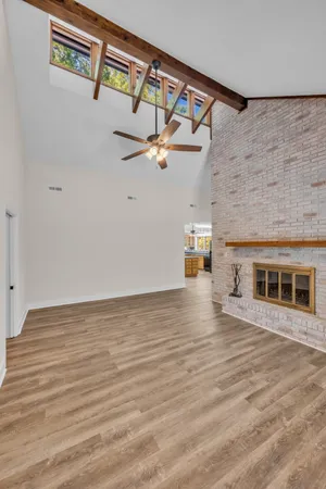 a view of an empty room with a ceiling fan