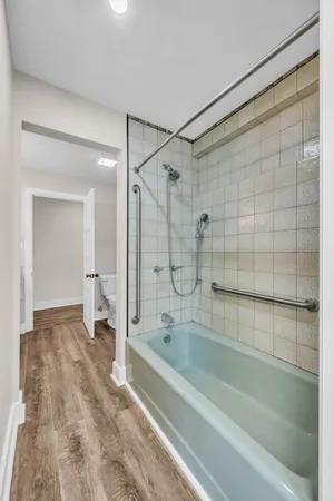 a bathroom with a granite countertop sink a mirror and shower