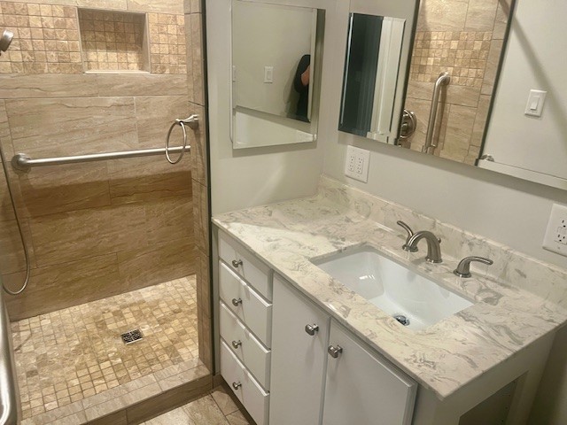 168 Oliver Smith Road Flintville, TN 37335 - Photo 46 of 86 a bathroom with a granite countertop sink a mirror and shower