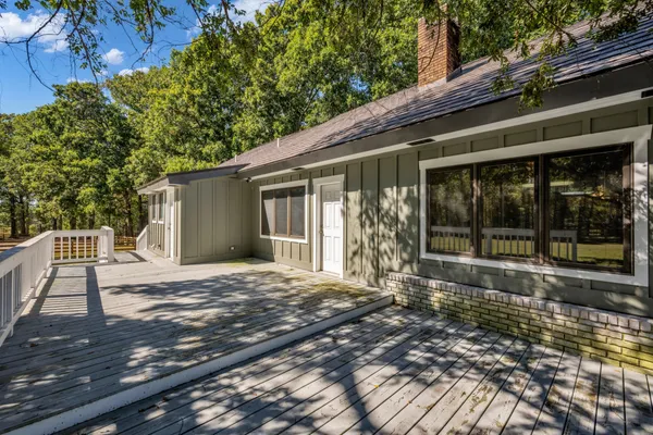 a view of outdoor space with deck and trees