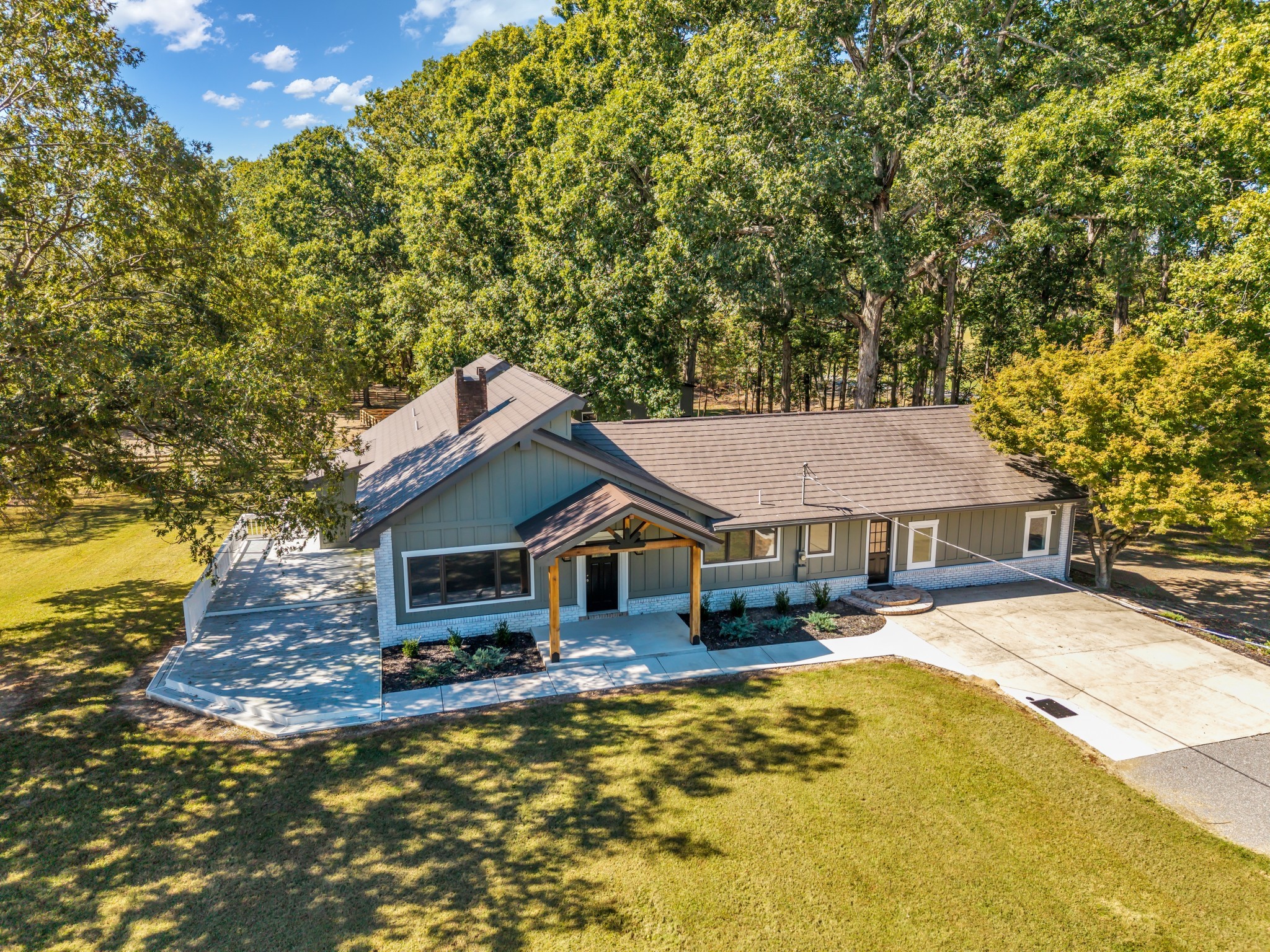 168 Oliver Smith Road Flintville, TN 37335 - Photo 5 of 86 a front view of a house with a yard outdoor seating and covered with trees