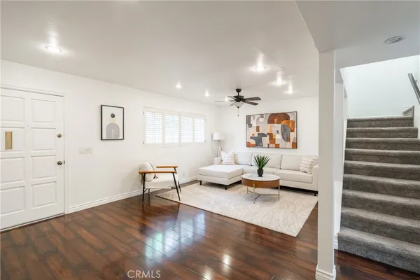 a living room with furniture and wooden floor