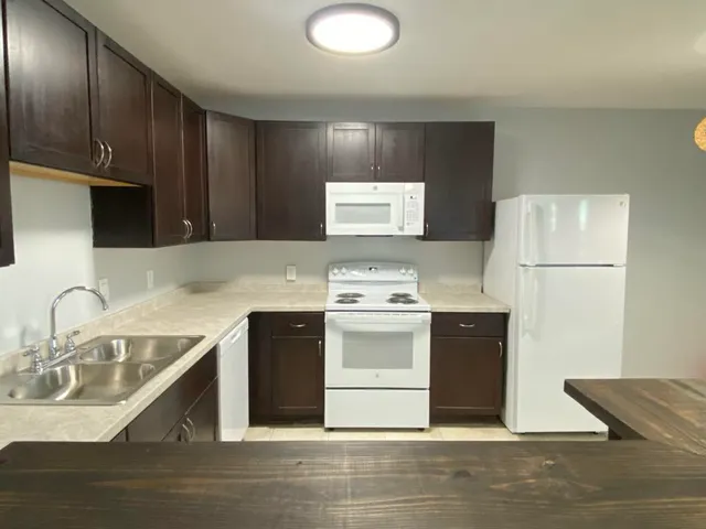 a kitchen with a sink cabinets and stainless steel appliances