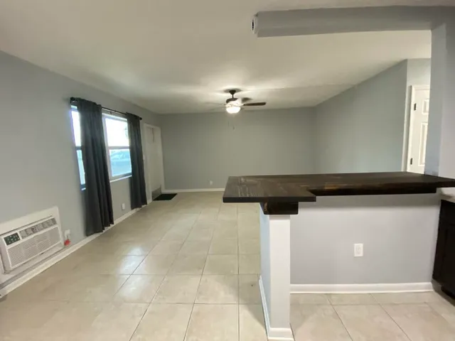 a view of a hallway with a kitchen